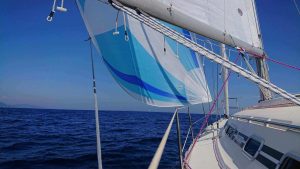 blue and white asymmetrical spinnaker on Beneteau