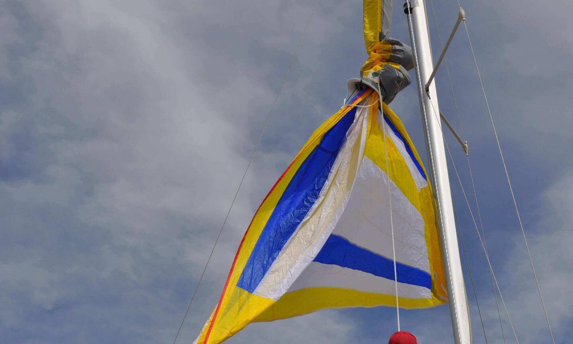 spinnaker sock sleeve on yellow white blue asymmetrical spinnaker