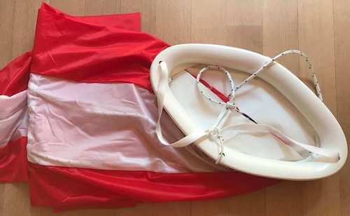 red spinnaker sock with white channels and white mouth