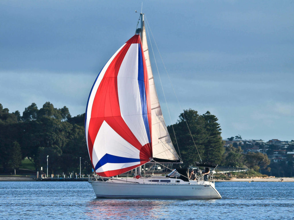 Jeanneau sun odyssey 32 asymmetrical tricolore spinnaker sailing in Australia