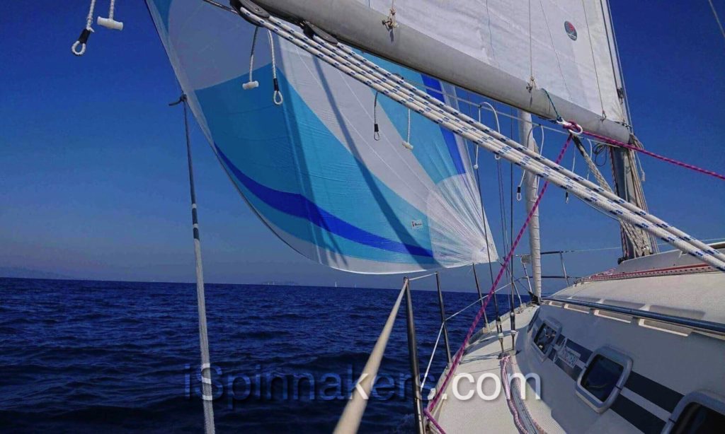 Beneteau First 310 with custom colors asymmetrical spinnaker blue white